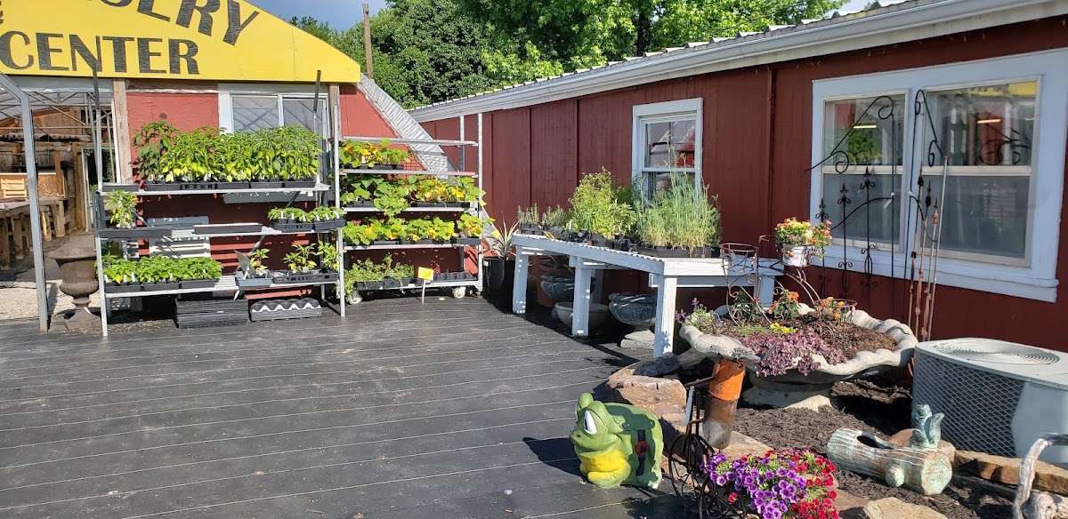 The Ozark Nursery building on N Main St Rd with plant benches out front